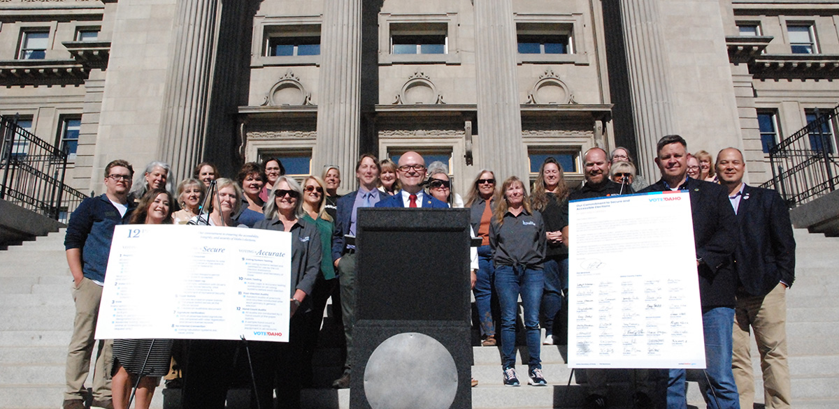 Idaho Secretary of State Phile McGrane standing with a large group of Idaho County Clerks on the Idaho State Capitol steps.